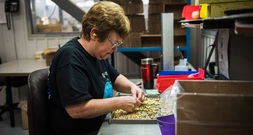 Lemire precision employee working in the factory